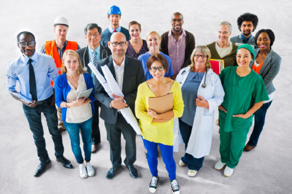 Fifteen diverse employees dressed for various jobs